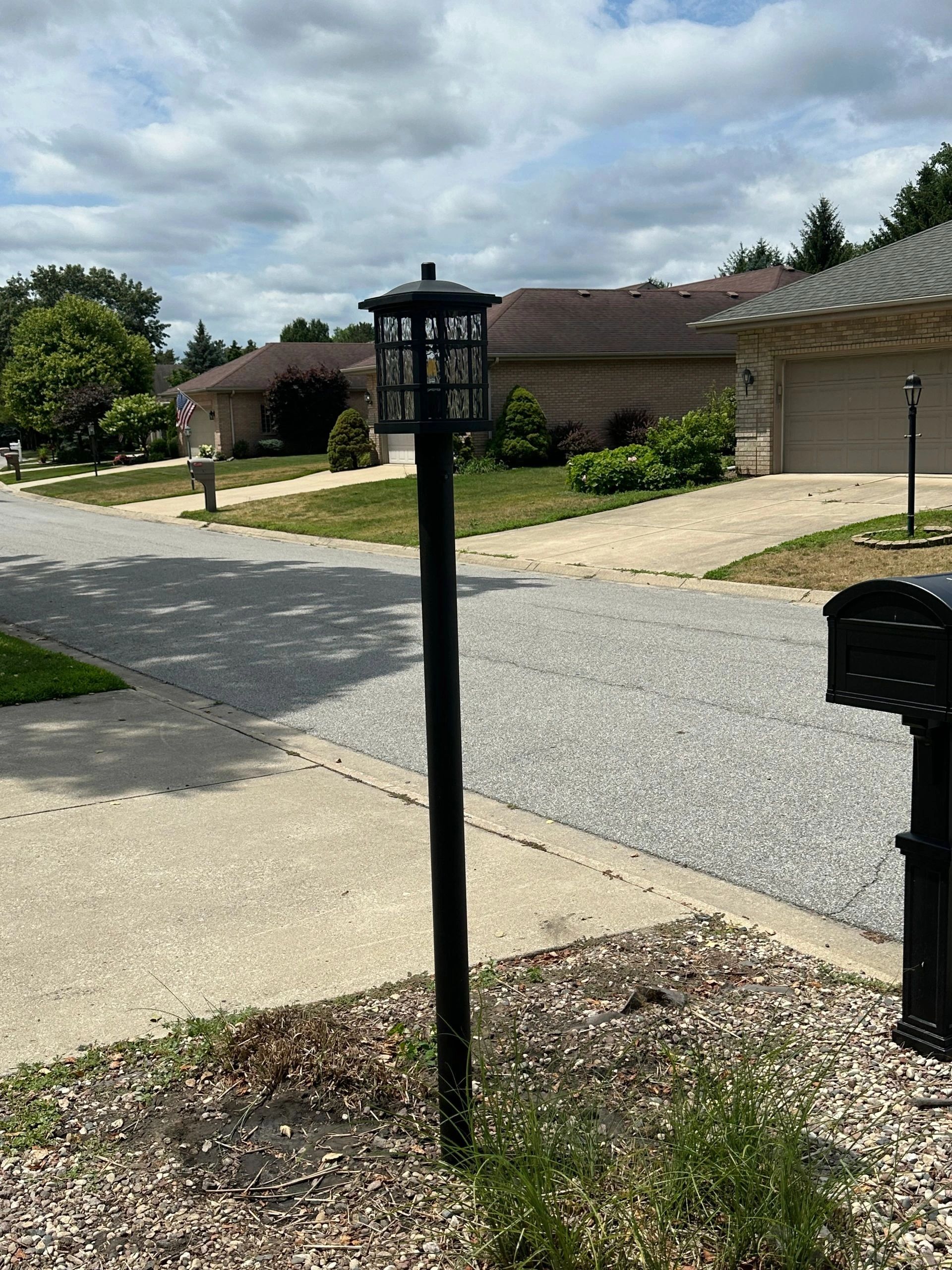 Decorative black post light in suburban street